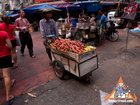 Pushing a Fruit Cart Through a Busy Market