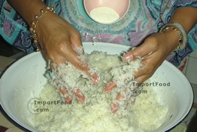Thai Street Vendor for Thai Fermented Sweet Rice Dessert, 'Khao Mahk' - Step 9<br>Sprinkle ground up yeast ball over rice.