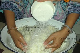 Thai Street Vendor for Thai Fermented Sweet Rice Dessert, 'Khao Mahk' - Step 8<br>Put in large bowl. Sprinkle sugar over the rice and mix gently.