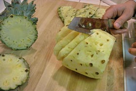 Peel and Slice Fresh Pineapple - Remove eyes as shown, from top to bottom, in a diagonal pattern