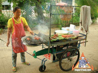 Thai Street Vendor Prepares Charcoal Barbequed Traditional Sausage, 'Nam'
