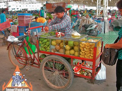Thai Street Vendor Offers Fresh Fruit from a Bicycle Cart
