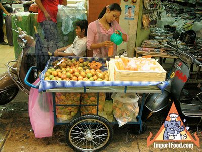 Thai Street Vendor Prepares Fresh Tangerine Juice, 'Nam Som'