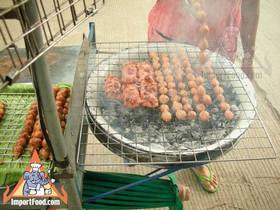 Thai Street Vendor Prepares Charcoal Barbequed Traditional Sausage, 'Nam'