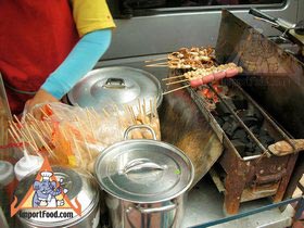 Thai Street Vendor Prepares Charcoal Barbequed Snacks, 'Luke Chinping'