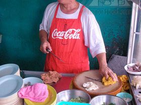 Thai Street Vendor Offers Khao Man Gai from a Shophouse Cart