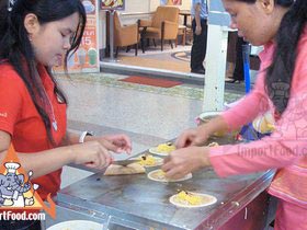 Thai Street Vendor Prepares Thai-Style Pancakes, 'Khanom Buang'