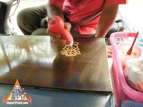 Thai Street Vendor Prepares Decorative Pancakes