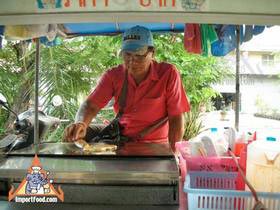 Thai Street Vendor Prepares Decorative Pancakes