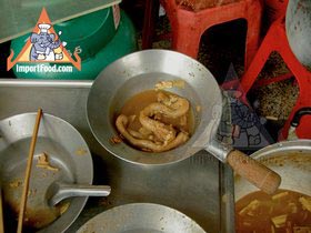 Thai Street Vendor Offers Chinese Herbal Soup from a Shophouse Cart