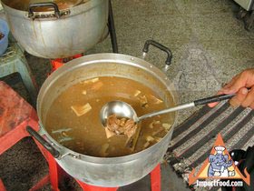 Thai Street Vendor Offers Chinese Herbal Soup from a Shophouse Cart