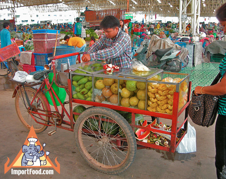 Thai Street Vendor Offers Fresh Fruit from a Bicycle Cart